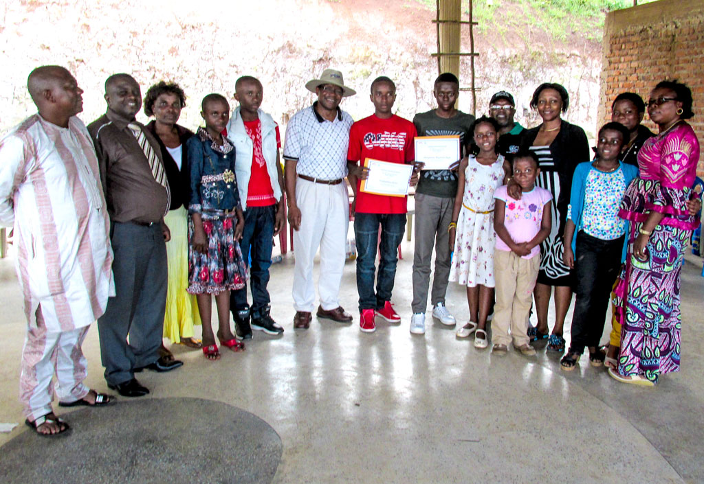 Okafor (in a hat) poses for a group photo with the winners of IITA Women Group scholarships for 2013 and their families