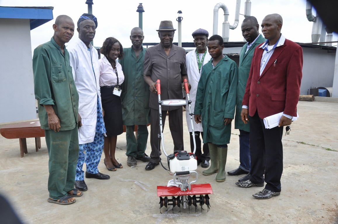 Project Leader, Cassava Weed Management, Dr Alfred Dixon with an imported motorized weeding machine flanked by IITA staff and Nigerian Engineers.