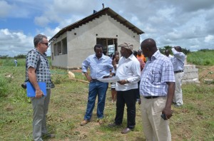 DG Sanginga conferring with Dr Chikoye on progress of construction of cassava equipment fabrication facility (at background) as Mr Bishop (at left) and Dr Ntwaruhunga (right) look on