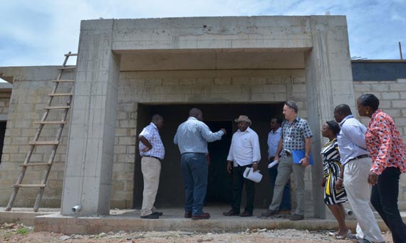 DG Sanginga being briefed by the contractor, Mr Banda, about the main research and administrative building.