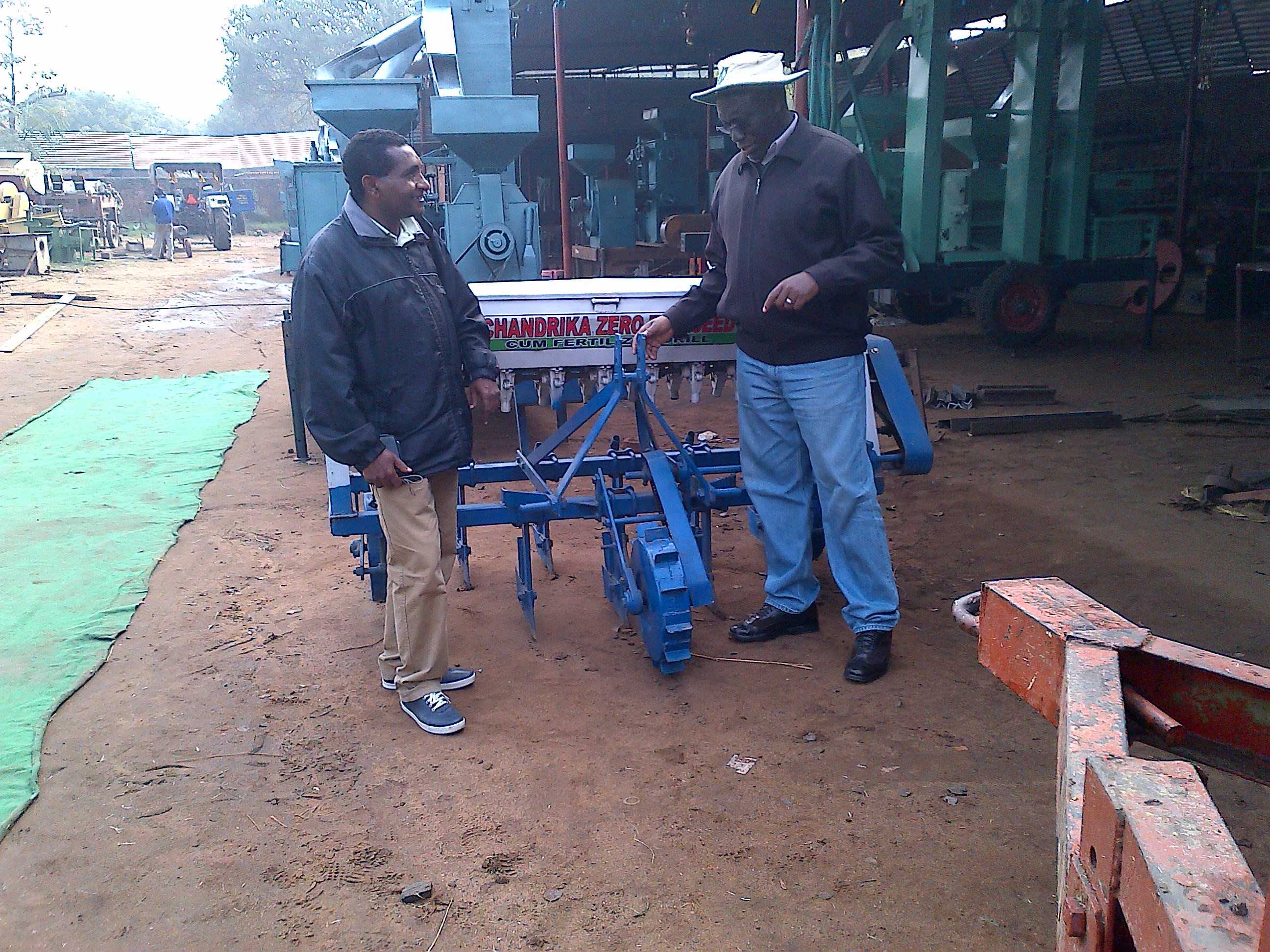 Africa RISING scientists Mateete Bekunda from IITA (right) and Kindu Mekonnen from ILRI (left) look at a mechanical seeder manufactured for use by small-scale farmers in India. The mechanical seeder is manufactured through a public-private partnership between the Cereal Systems Initiative for South Asia (CSISA) and the private sector.