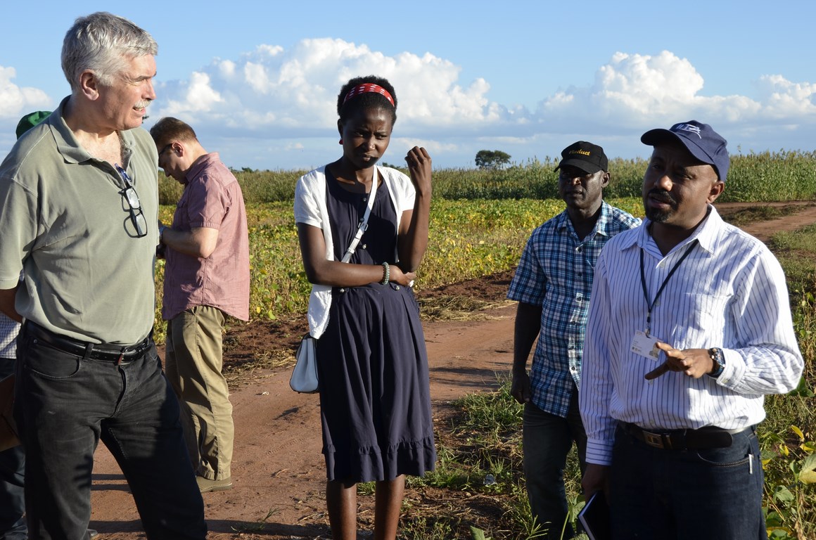 Dr Rob Bertram (left) listening to a presentation by Dr Alene Arega of IITA on a soy demonstration field.