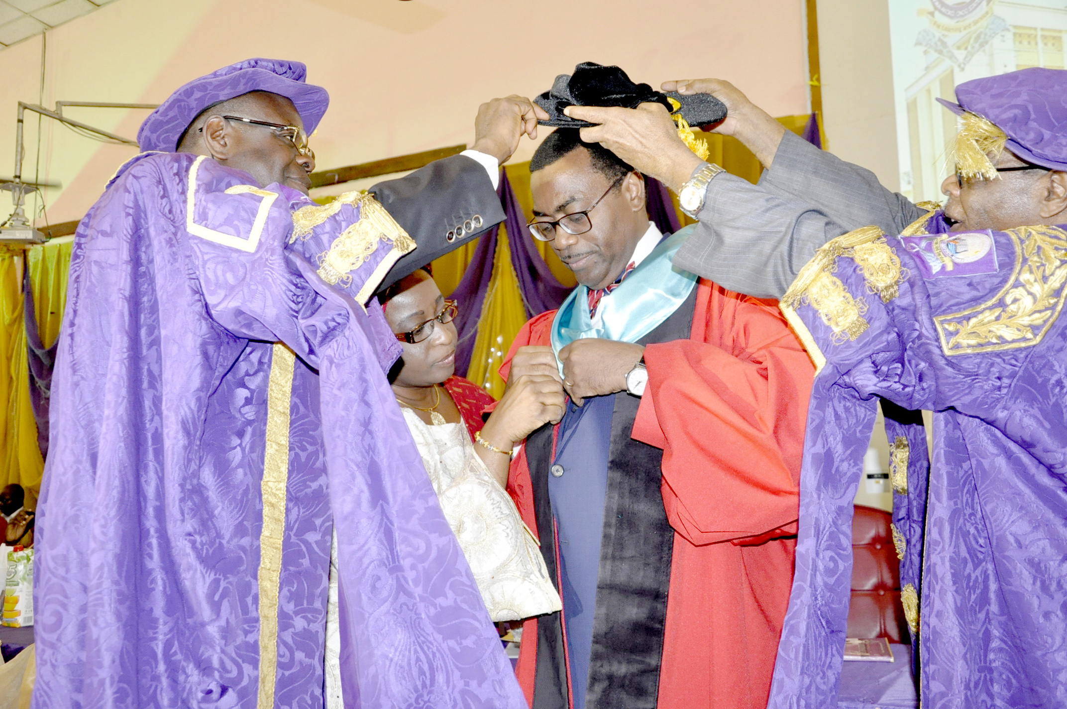 Dr Akinwumi Adesina receiving his cap and gown during the conferment ceremony.