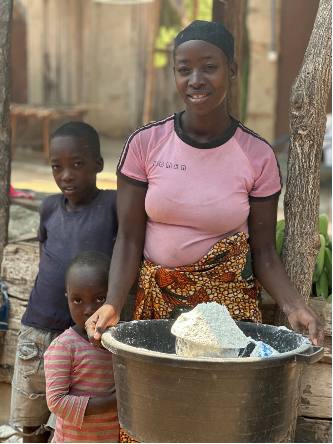 A Cassava entrepreneur and her children selling cassava flour on market day: Photo Credit: Sarah Msita