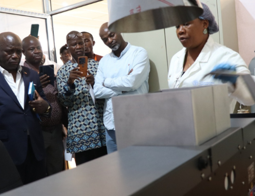 Deputy Minister for Technical Services, Honorable Solomon Hedd-Williams with others at the commissioning of the AAS in the soil testing lab.
