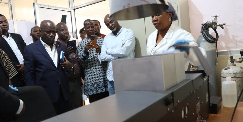 Deputy Minister for Technical Services, Honorable Solomon Hedd-Williams with others at the commissioning of the AAS in the soil testing lab.