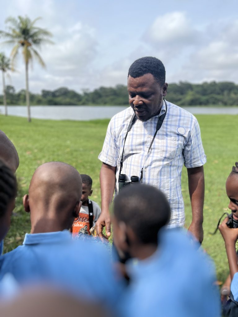 Ademola Ajayi guiding students during the birdwatching session]Caption: Student gets hands-on guidance from Ademola Ajayi of the IITA Forest Centre during the birdwatching exercise. Photo: Ogheneovie Kome 